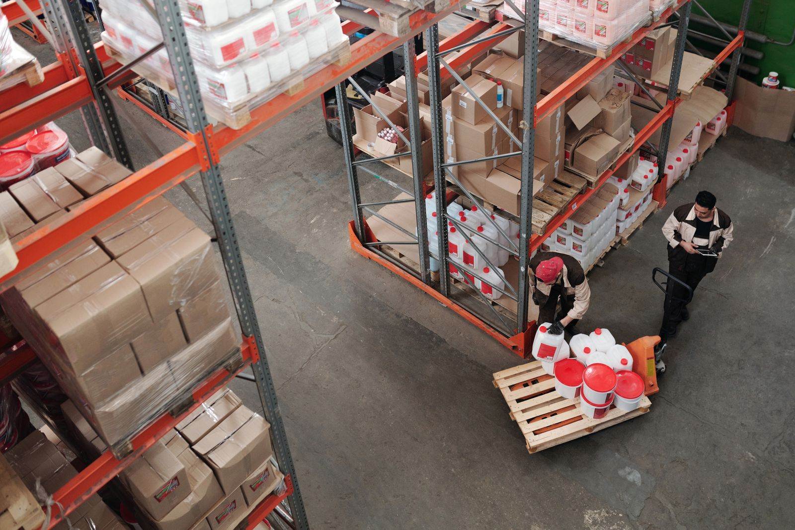 High angle view of workers organizing inventory in a busy warehouse